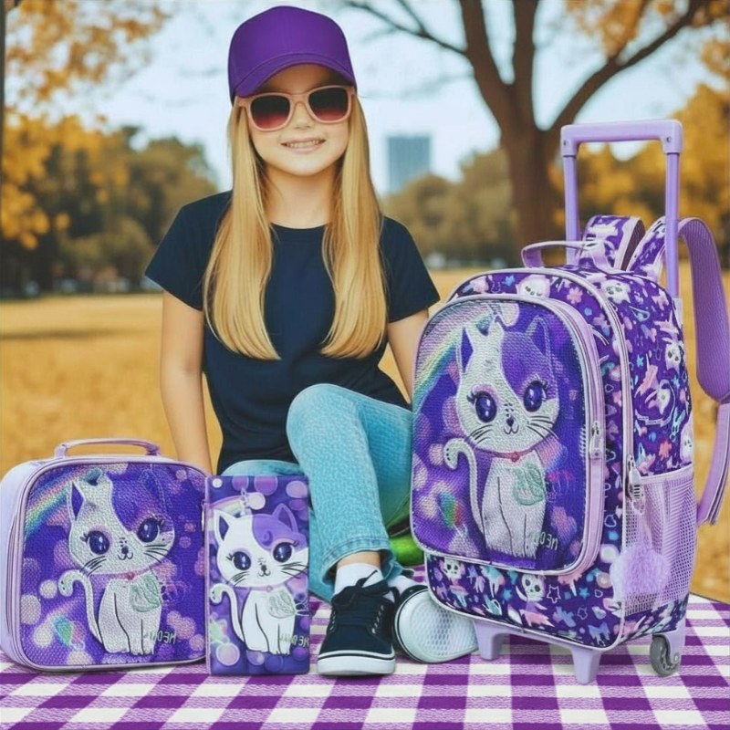 Person sitting with purple-themed luggage set featuring cartoon cat design outdoors.