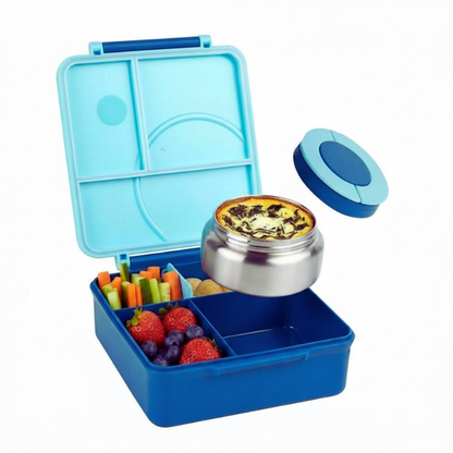 Blue bento box with compartments filled with food items on a white background
