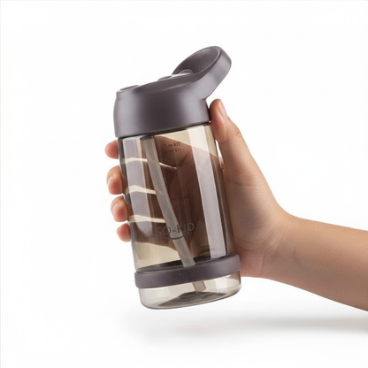 Hand holding a clear water bottle 